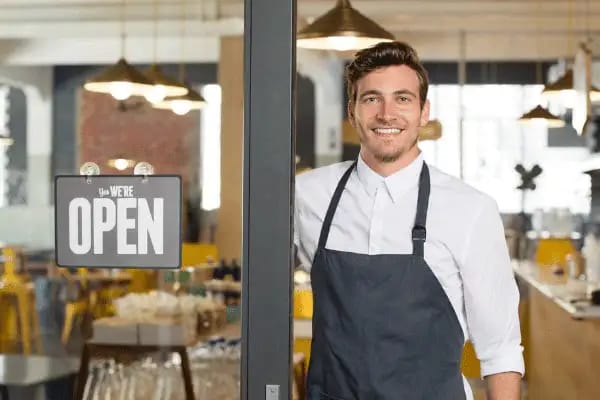 A small business owner outside their commercial premises.