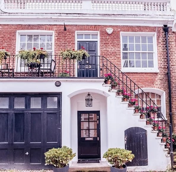 A row of red-brick period terraced houses on a UK residential street.