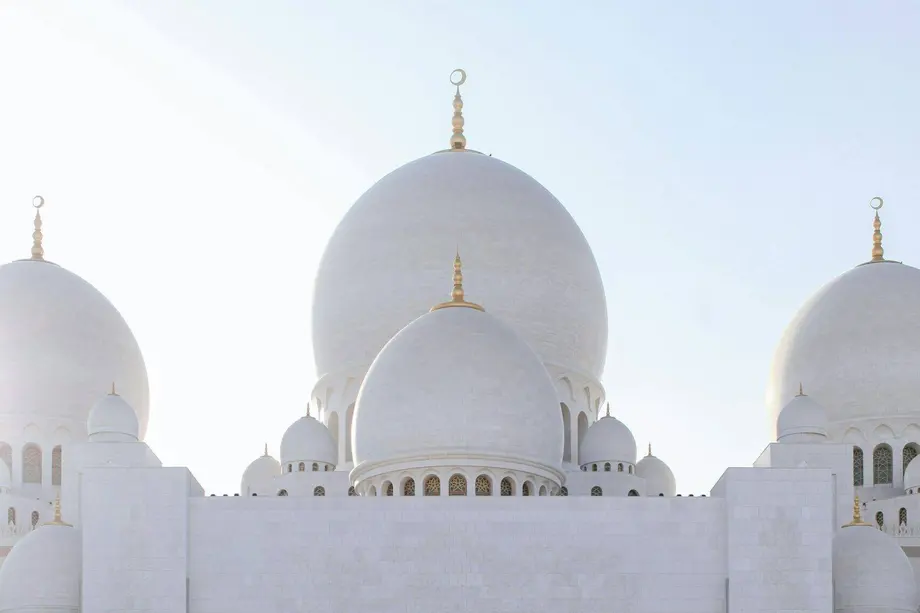 The white marble domes of the Sheikh Zayed Grand Mosque in Abu Dhabi